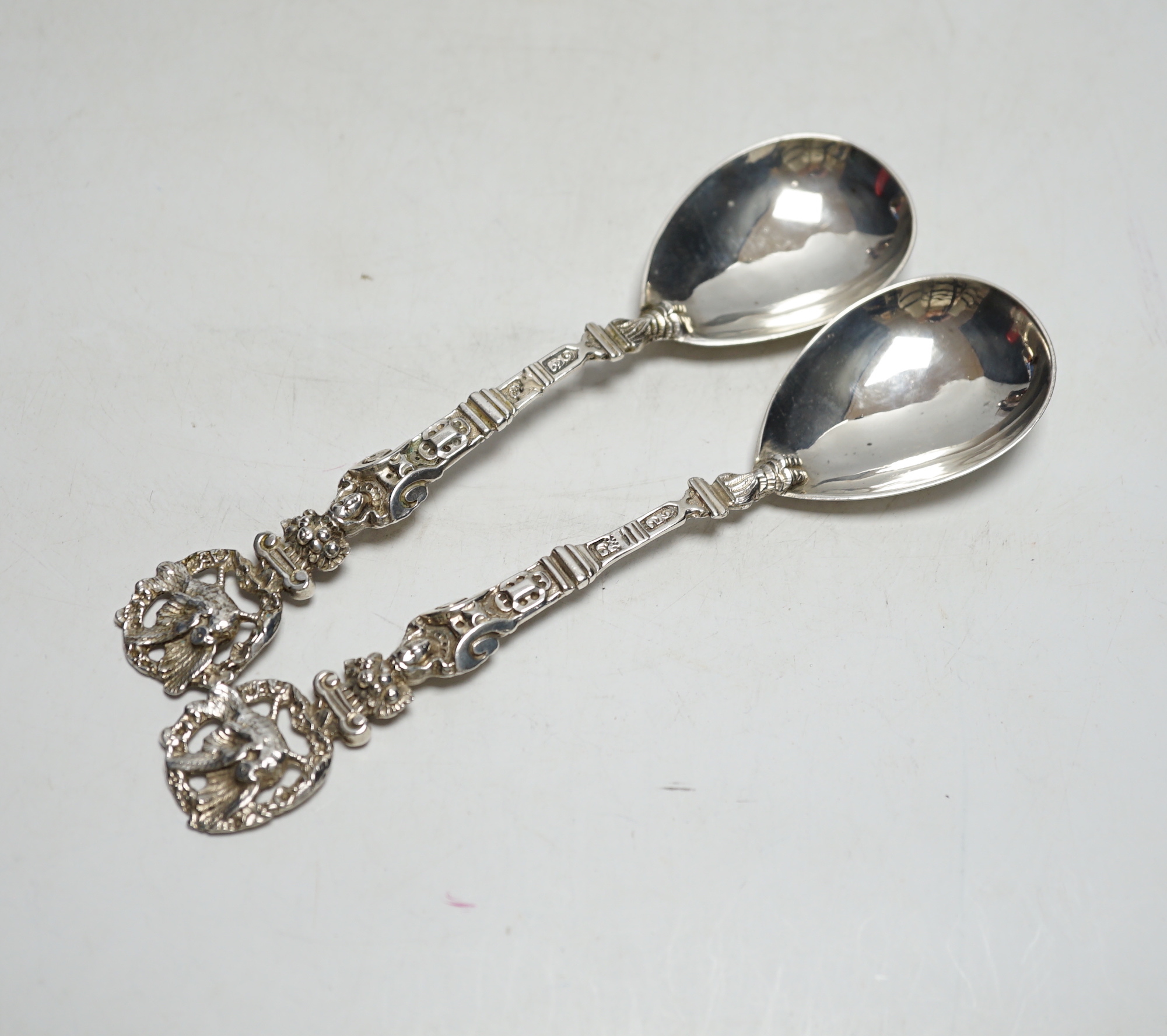 A pair of Victorian silver serving spoons, with figural handles and phoenix terminals, Charles Boyton, London, 1882, 18.9cm, 4.2oz.